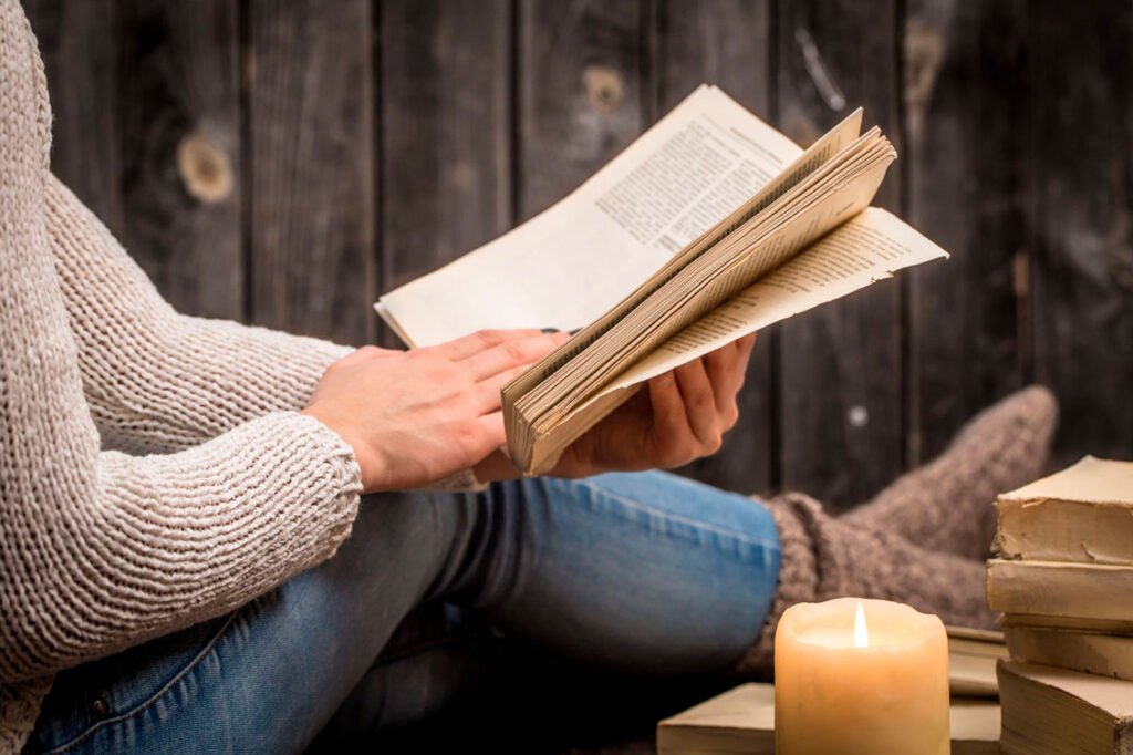 Una mujer lee libros de espiritualidad para el bienestar del alma y el espíritu